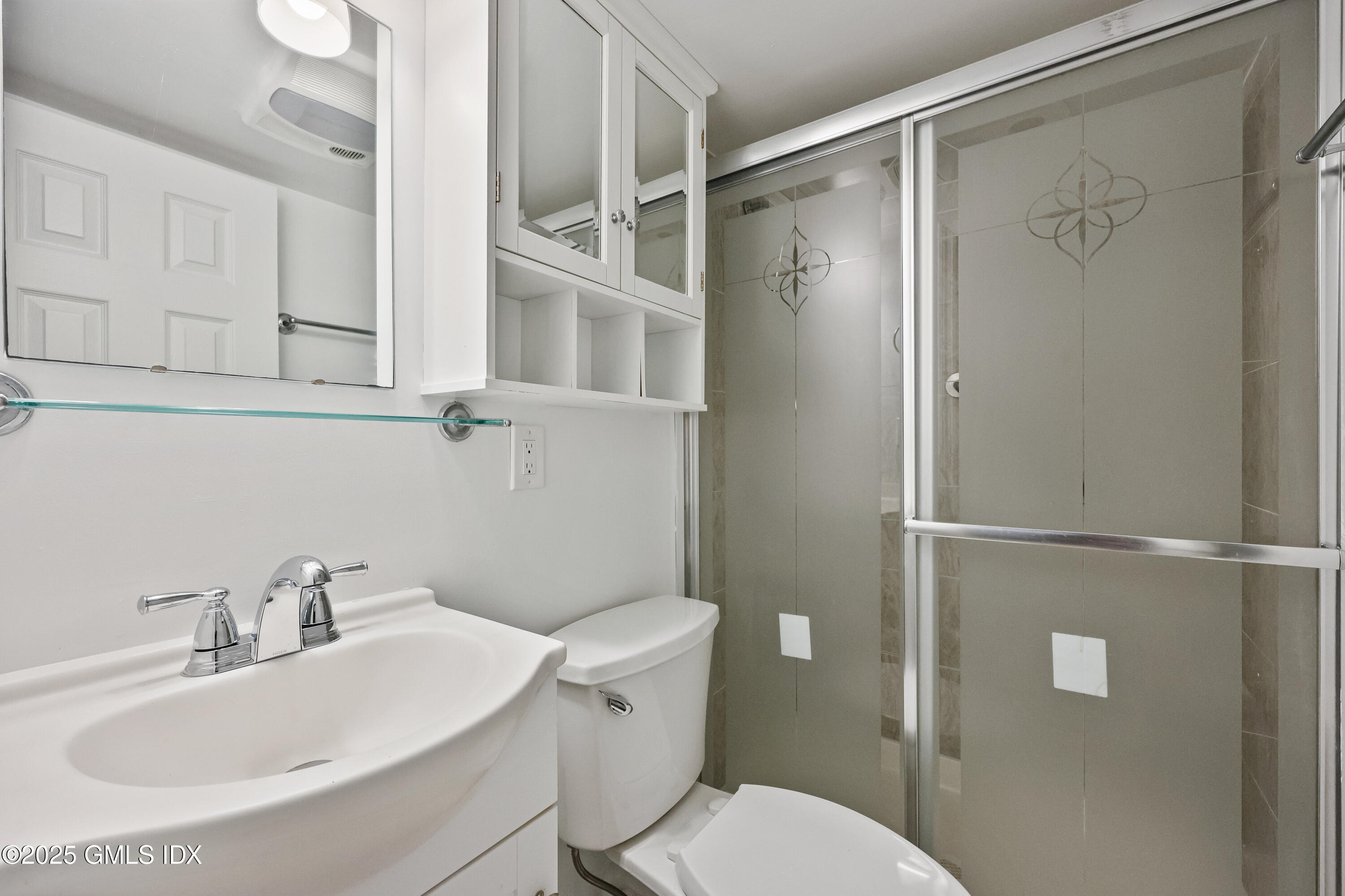 75 Cos Cob Avenue, Unit 14 Cos Cob, CT 06807 - Photo 21 of 28 a white toilet sitting next to a bathroom sink