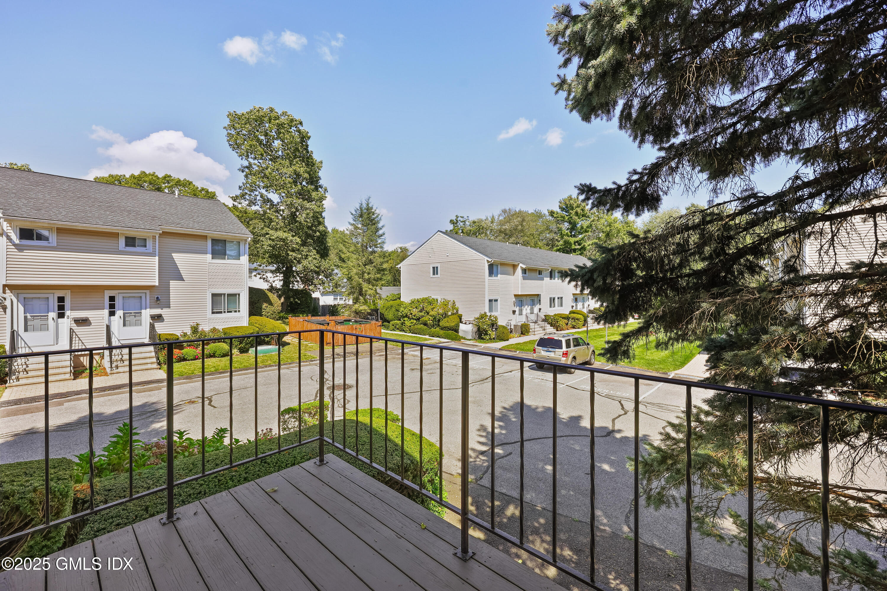 75 Cos Cob Avenue, Unit 14 Cos Cob, CT 06807 - Photo 23 of 28 a view of a balcony with a tree
