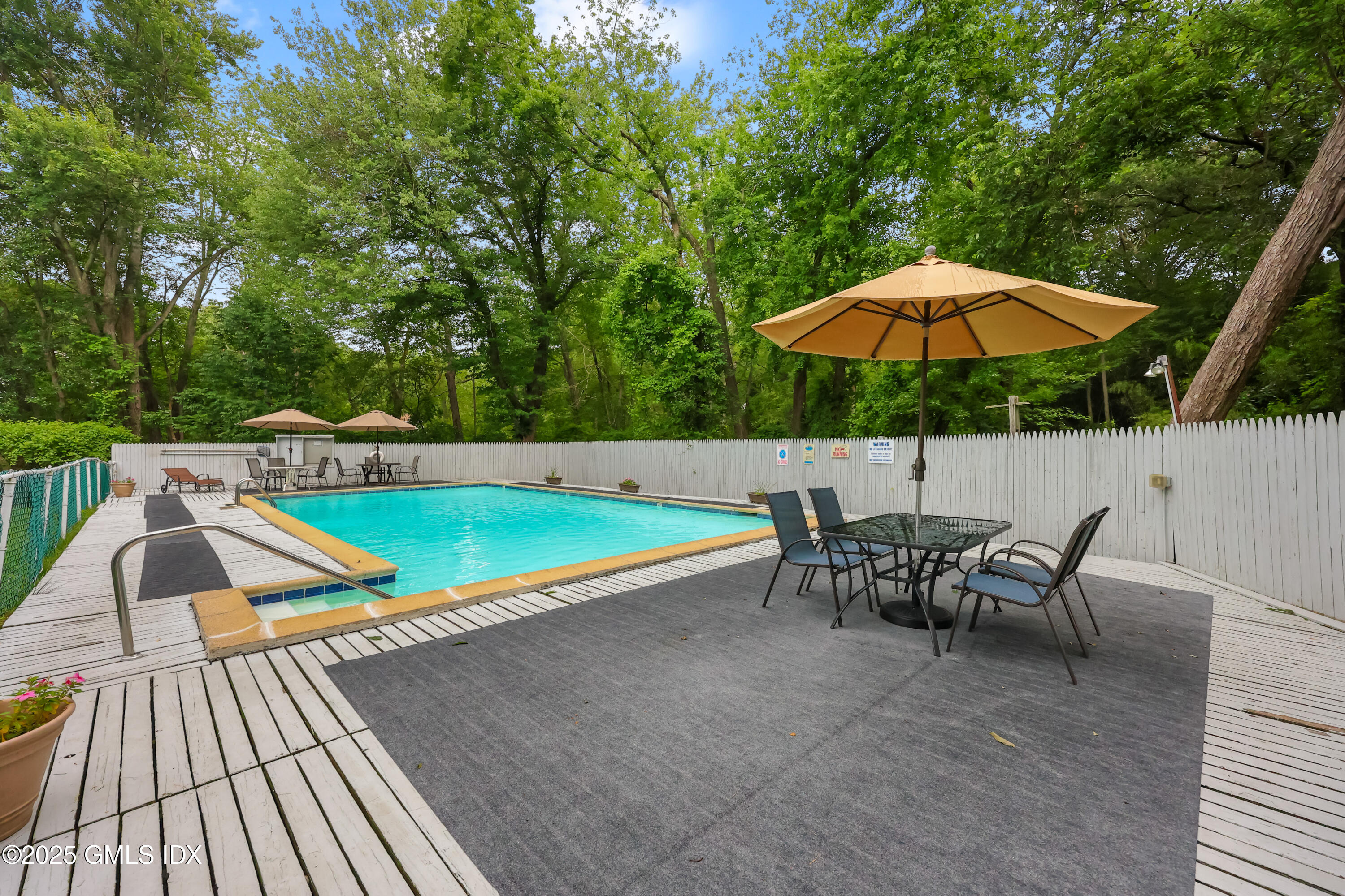 75 Cos Cob Avenue, Unit 14 Cos Cob, CT 06807 - Photo 26 of 28 an outdoor space with furniture and umbrella