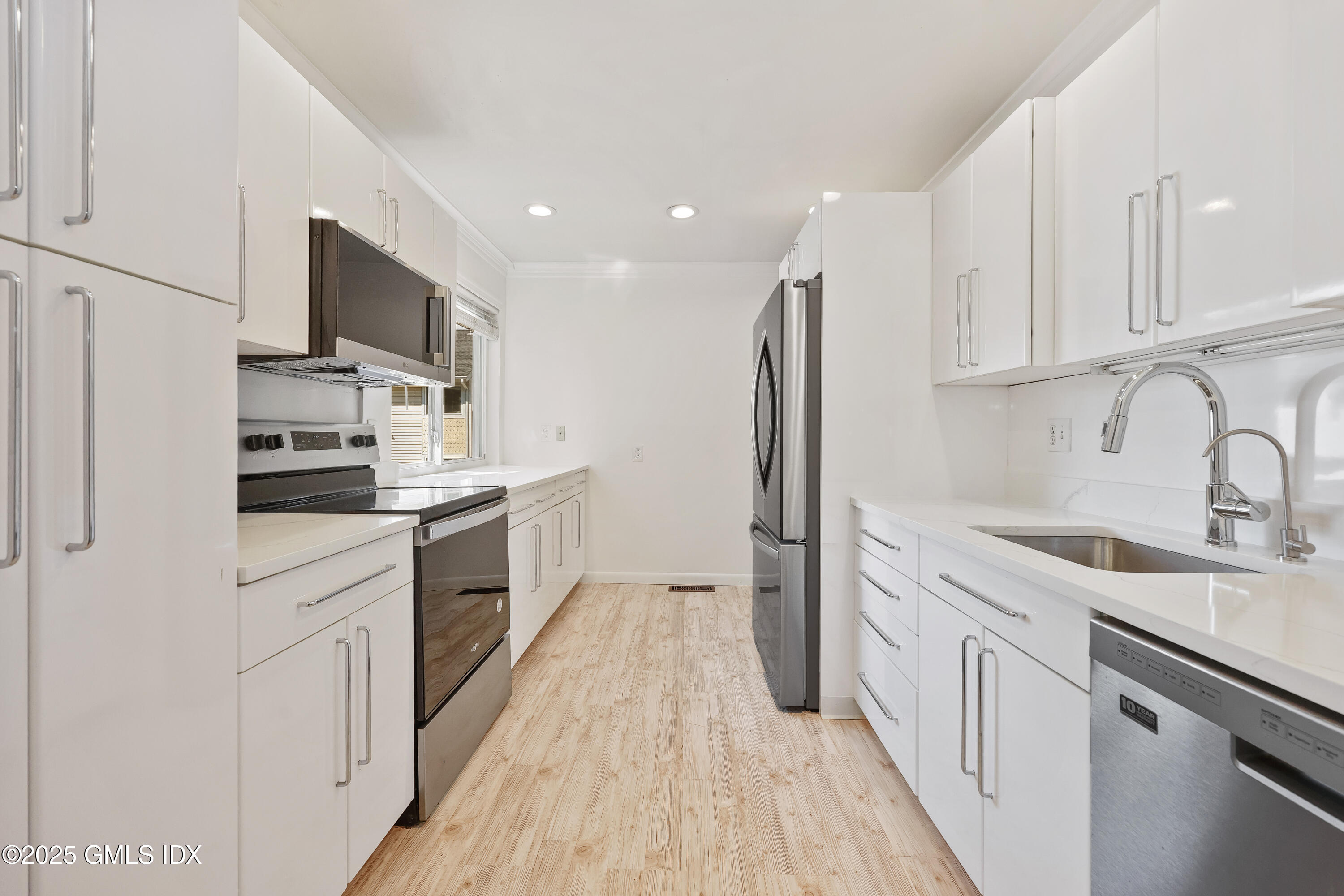 75 Cos Cob Avenue, Unit 14 Cos Cob, CT 06807 - Photo 3 of 28 a kitchen with stainless steel appliances a sink stove and refrigerator