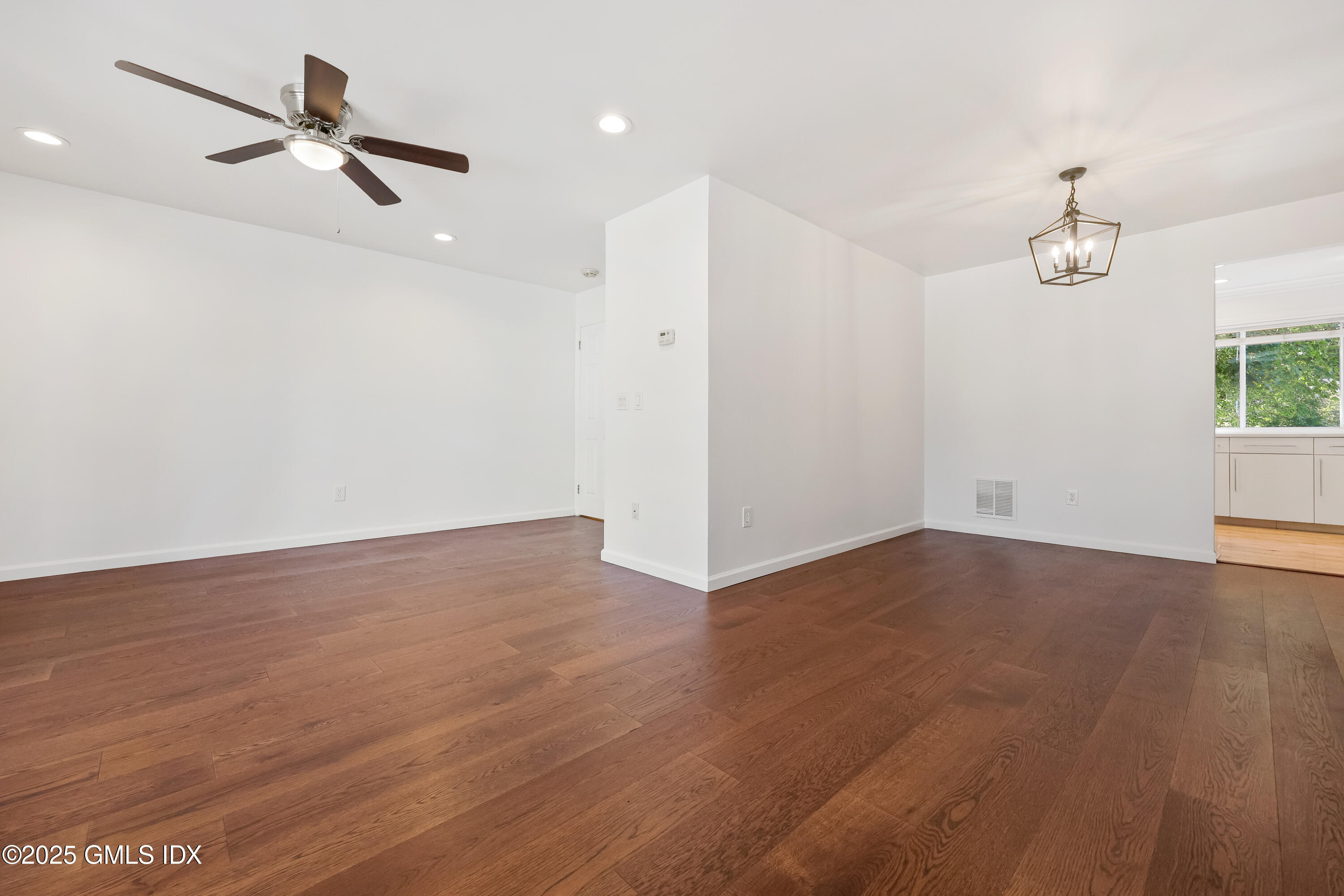 75 Cos Cob Avenue, Unit 14 Cos Cob, CT 06807 - Photo 6 of 28 an empty room with wooden floor ceiling fan and windows