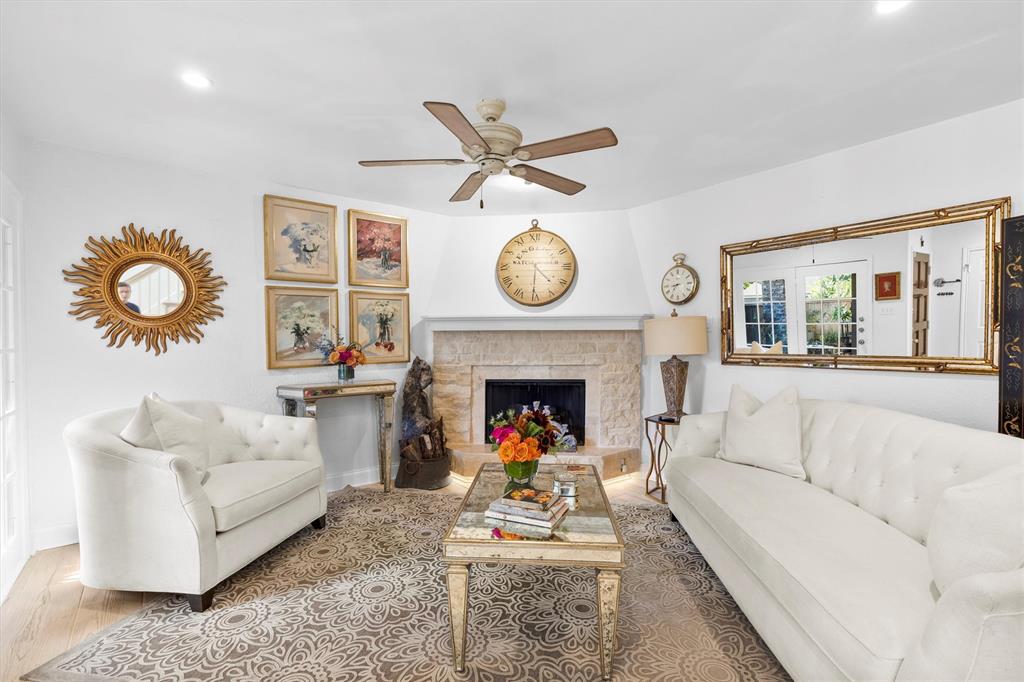 5200 Martel Avenue, Unit 32B Dallas, TX 75206 - Photo 1 of 35 a living room with furniture a clock and a fireplace