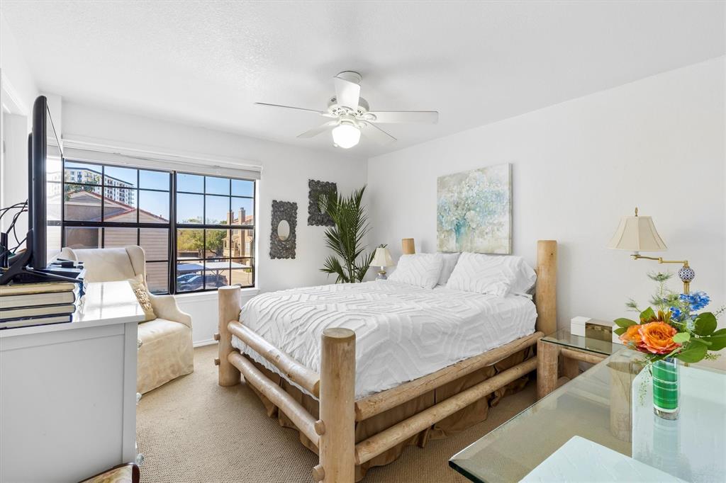 5200 Martel Avenue, Unit 32B Dallas, TX 75206 - Photo 13 of 35 a bedroom with a bed potted plant and a large window
