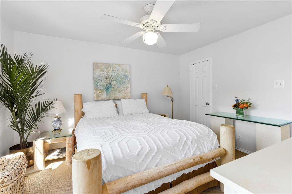 5200 Martel Avenue, Unit 32B Dallas, TX 75206 - Photo 14 of 35 a bedroom with a bed and a chandelier