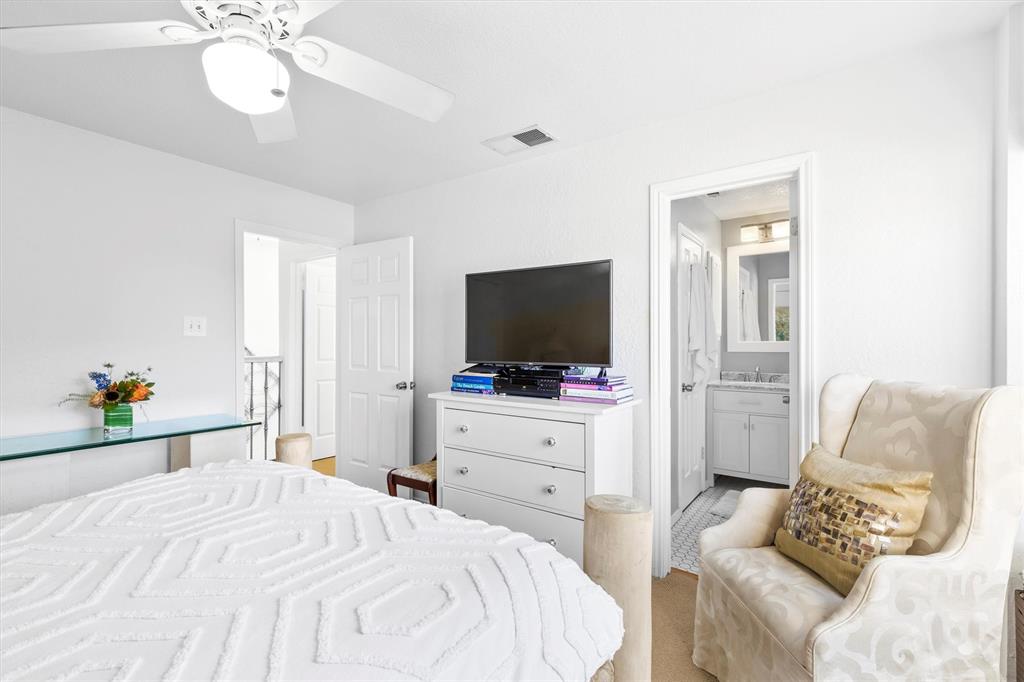 5200 Martel Avenue, Unit 32B Dallas, TX 75206 - Photo 15 of 35 a bedroom with a bed and a flat screen tv