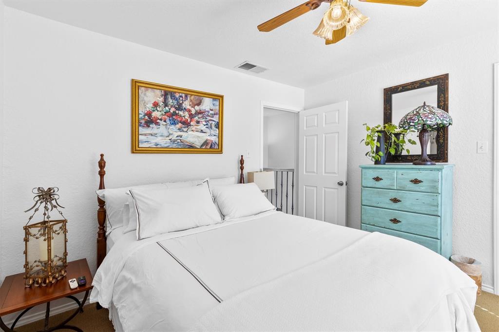 5200 Martel Avenue, Unit 32B Dallas, TX 75206 - Photo 19 of 35 a bedroom with a bed and a dresser