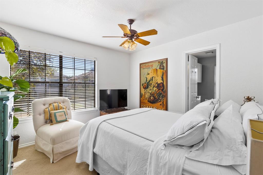 5200 Martel Avenue, Unit 32B Dallas, TX 75206 - Photo 20 of 35 a bedroom with a bed and a chandelier