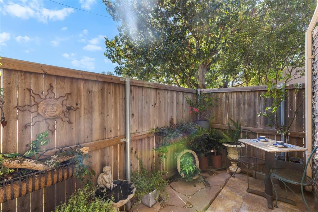 5200 Martel Avenue, Unit 32B Dallas, TX 75206 - Photo 22 of 35 a backyard of a house with chairs and a tree