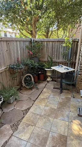 a view of backyard with a table and chairs