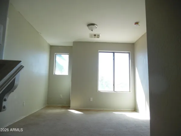 a room with a window and ceiling fan