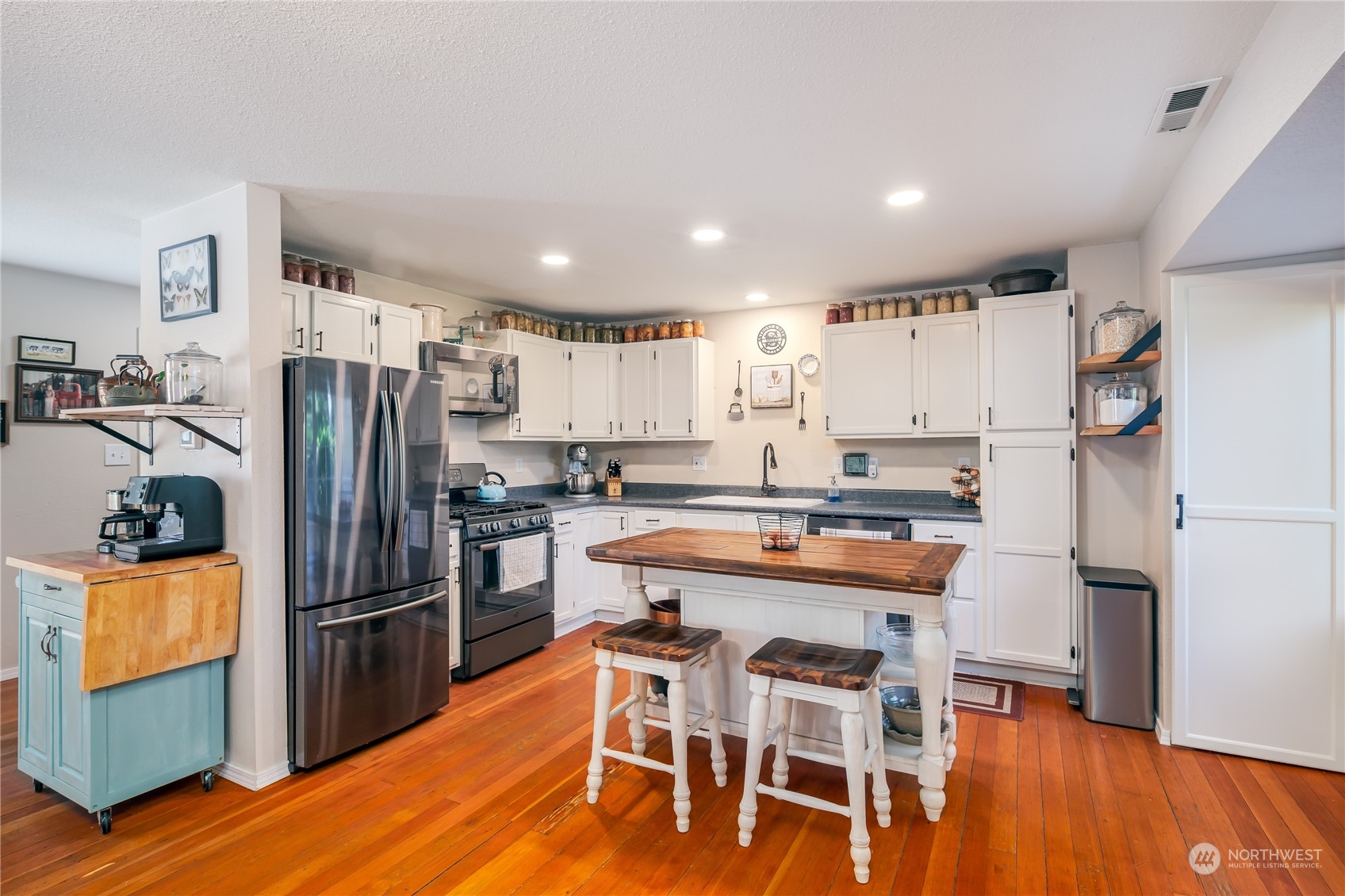 402 West 3rd Street Nooksack, WA 98276 - Photo 20 of 36 a kitchen with stainless steel appliances a refrigerator a stove a sink and chairs
