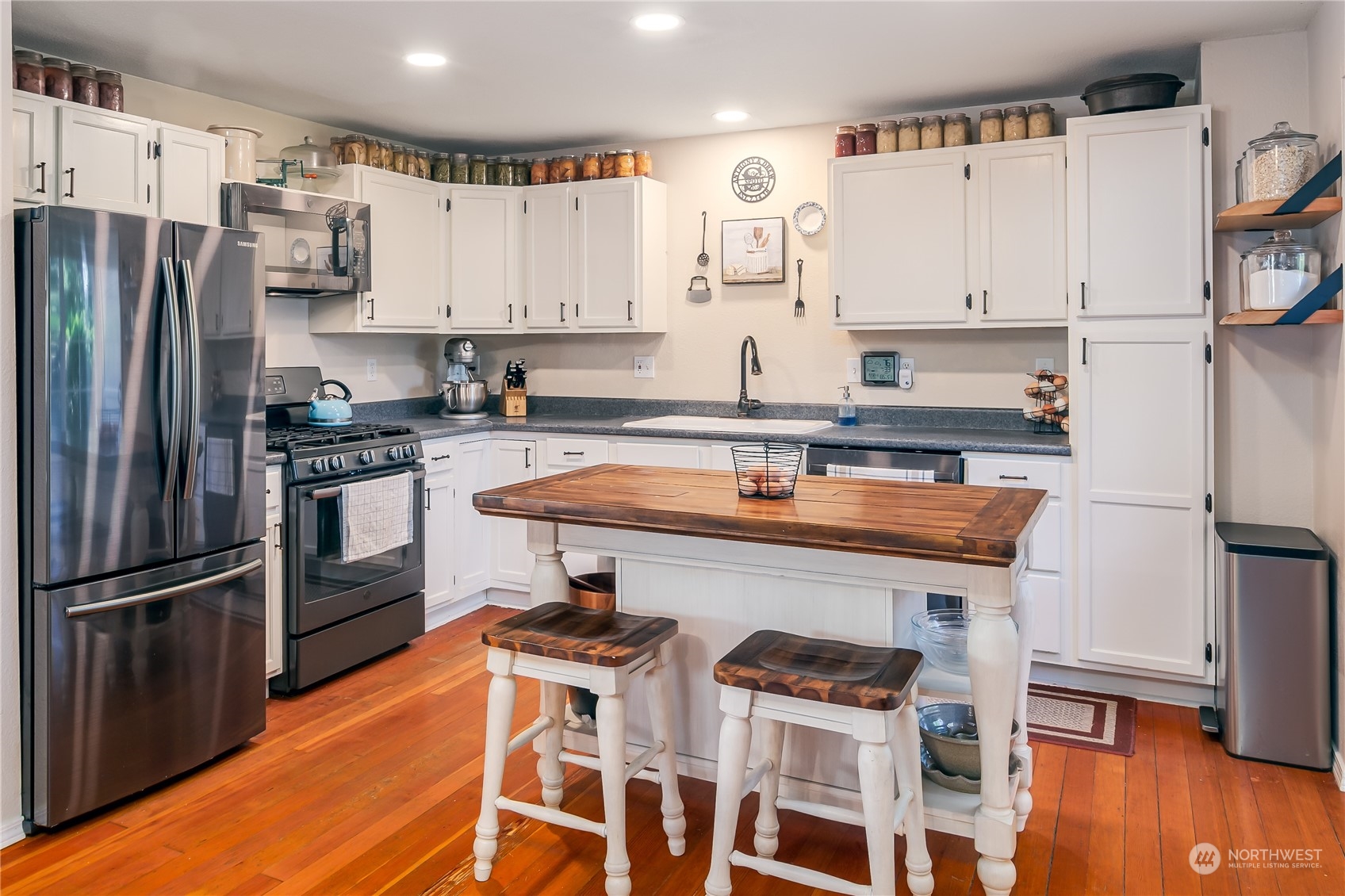 402 West 3rd Street Nooksack, WA 98276 - Photo 21 of 36 a kitchen with stainless steel appliances a stove a sink and a refrigerator