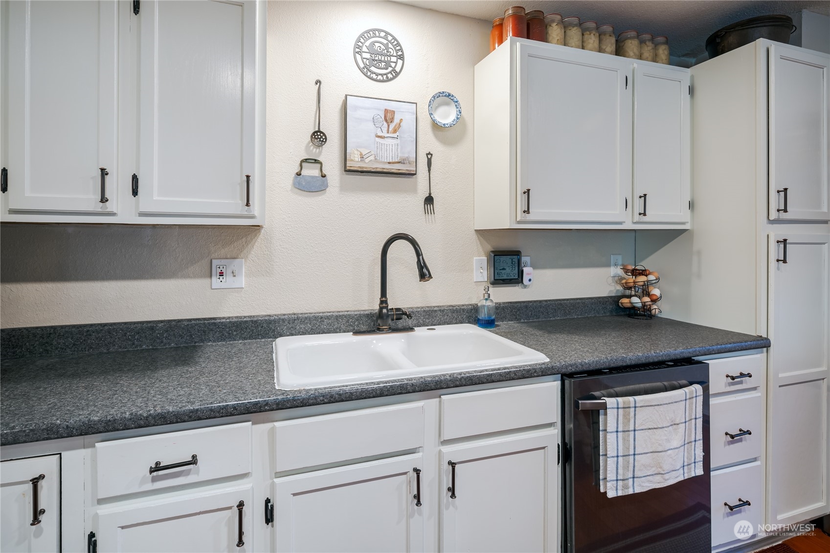 402 West 3rd Street Nooksack, WA 98276 - Photo 24 of 36 a kitchen with granite countertop a sink cabinets and stainless steel appliances