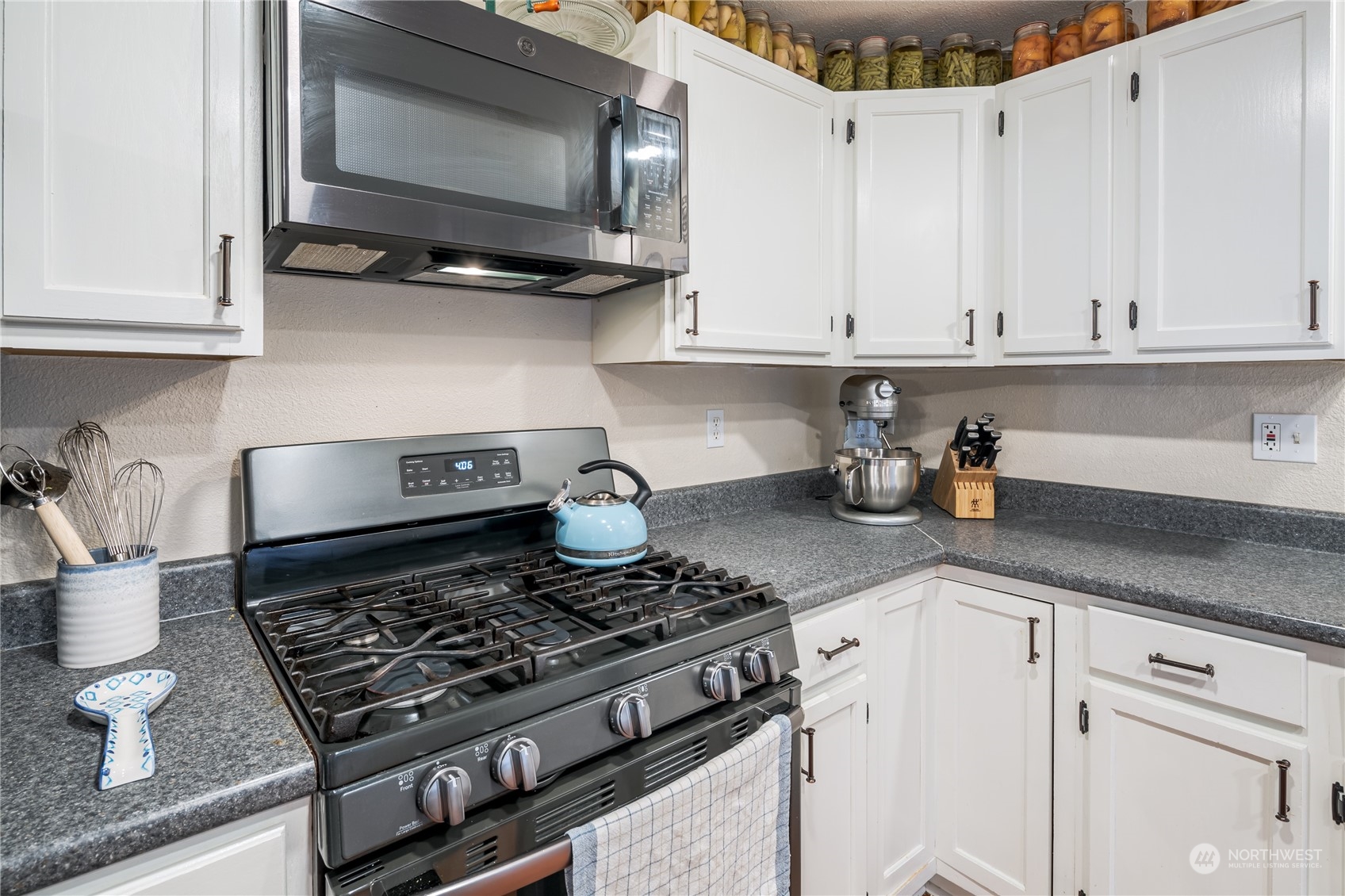402 West 3rd Street Nooksack, WA 98276 - Photo 25 of 36 a kitchen with stainless steel appliances granite countertop a stove a microwave and cabinets