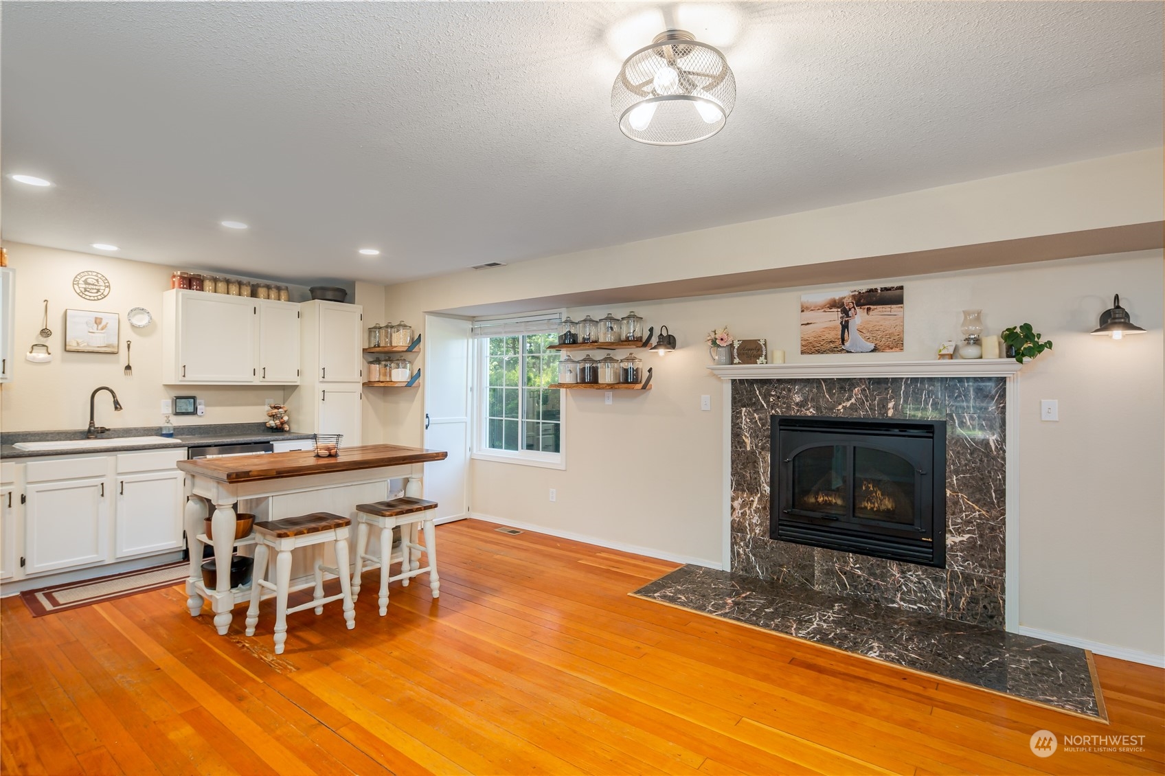 402 West 3rd Street Nooksack, WA 98276 - Photo 26 of 36 a living room with a dining table and a fireplace