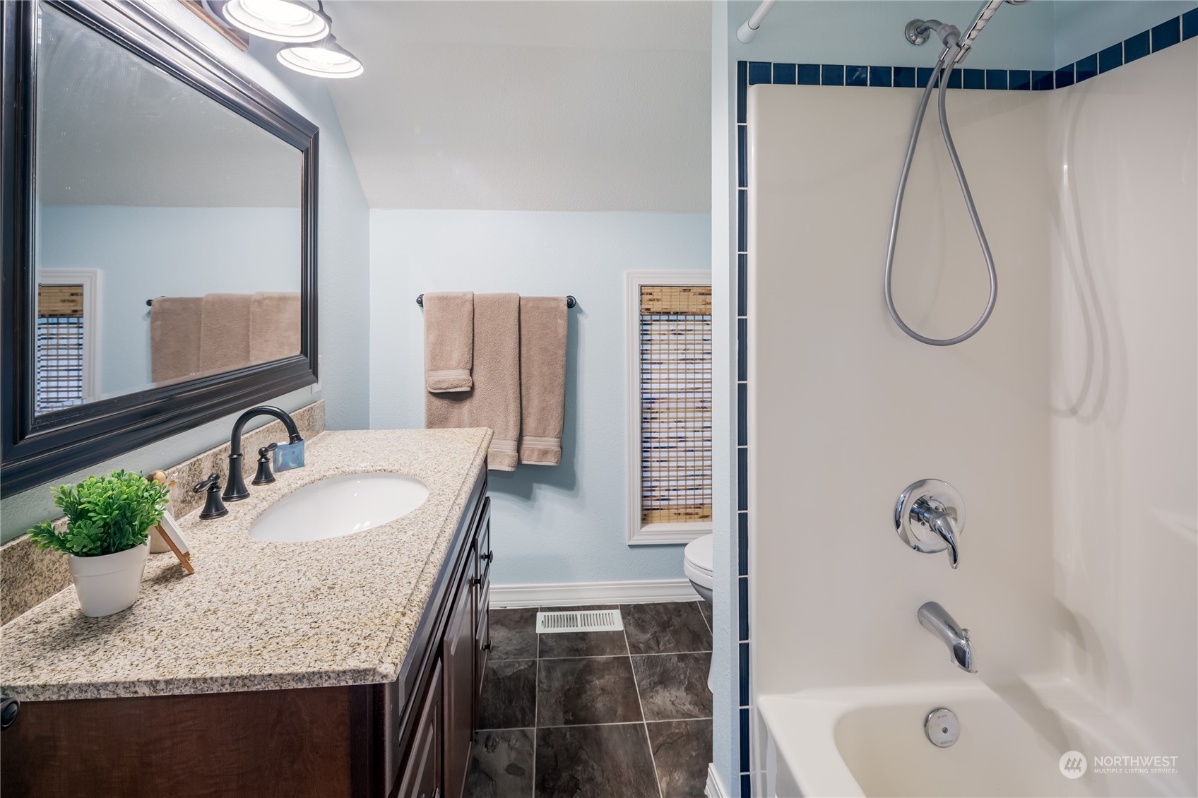 402 West 3rd Street Nooksack, WA 98276 - Photo 29 of 36 a bathroom with a granite countertop sink a mirror and shower