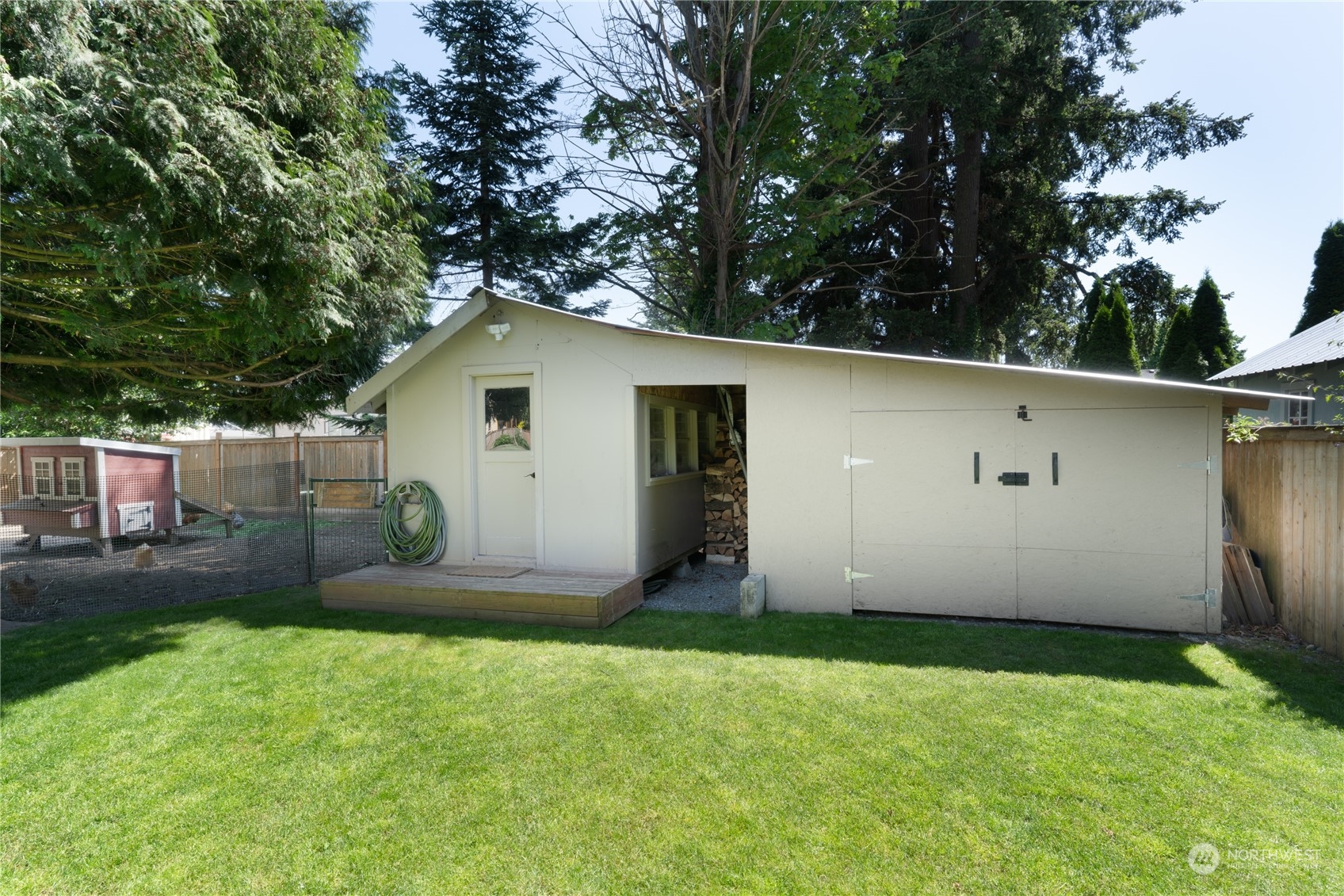 402 West 3rd Street Nooksack, WA 98276 - Photo 7 of 36 a white house that has a small yard and large trees