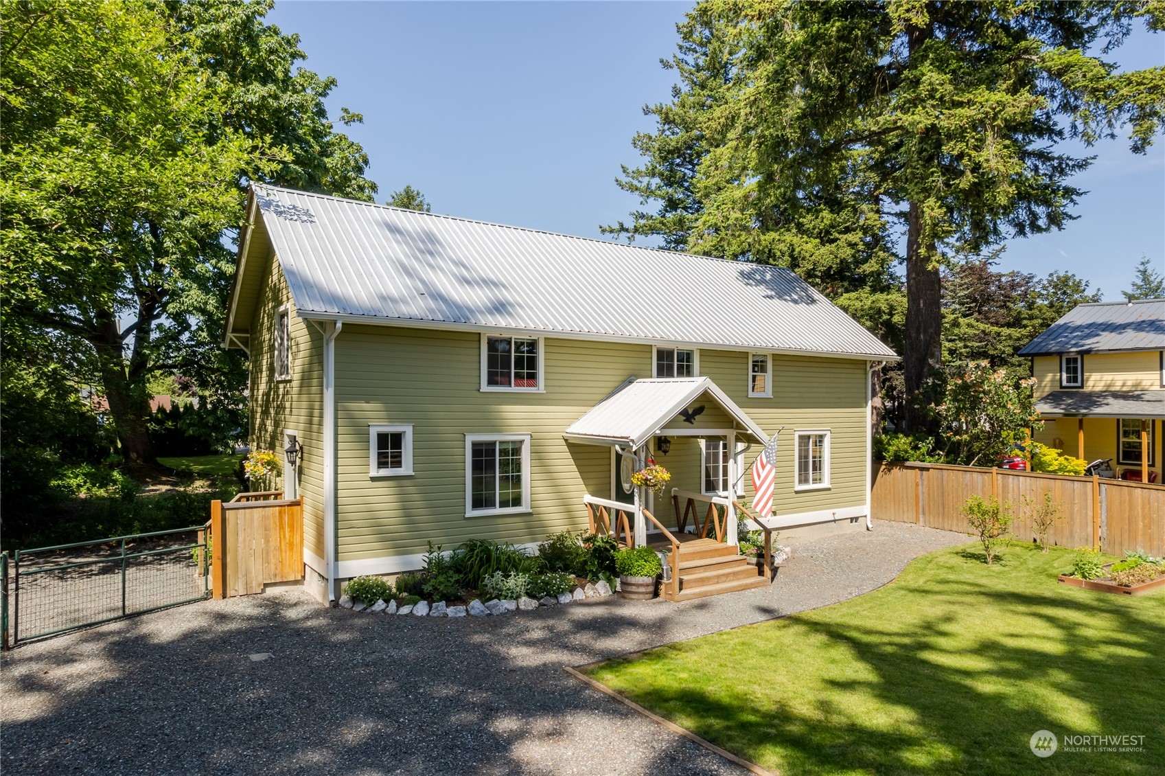 402 West 3rd Street Nooksack, WA 98276 - Photo 10 of 36 a view of a white house with a large pool lawn chairs and a yard