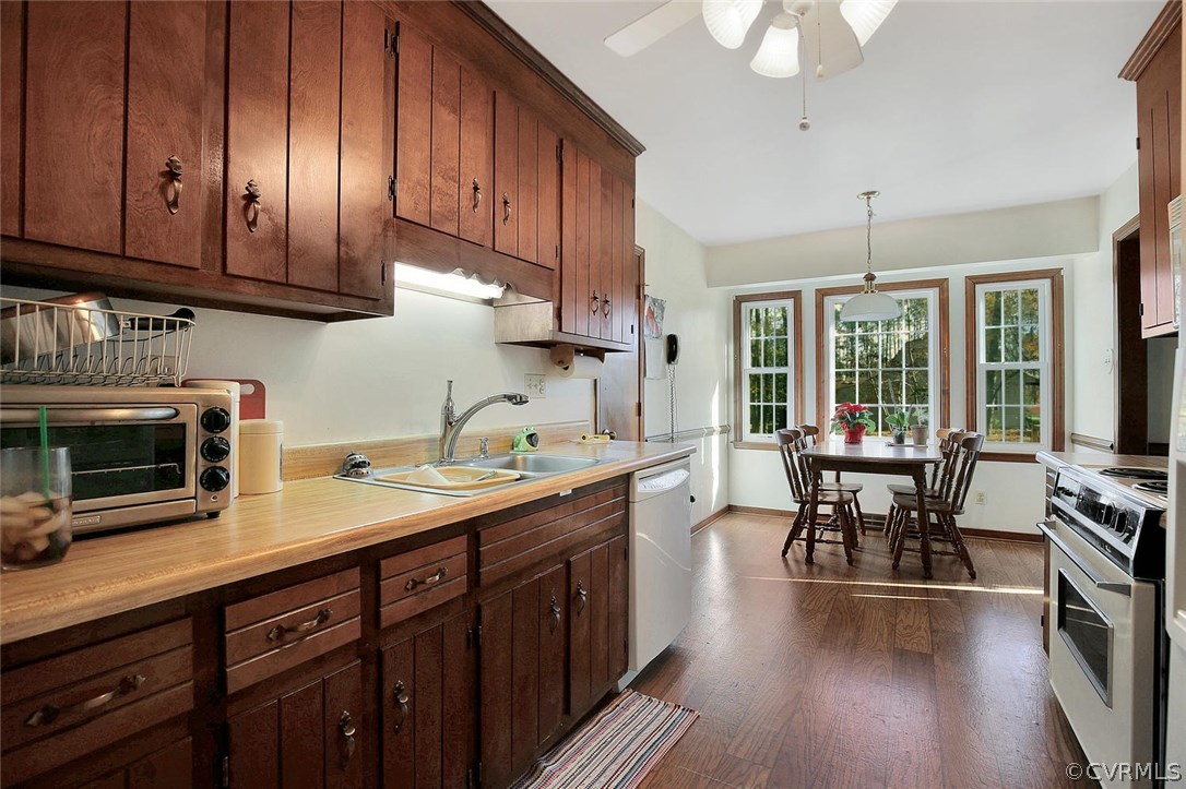 11301 Celtic Road Chesterfield, VA 23838 - Photo 13 of 27 a kitchen with stainless steel appliances granite countertop wooden cabinets a stove a sink and a wooden floors