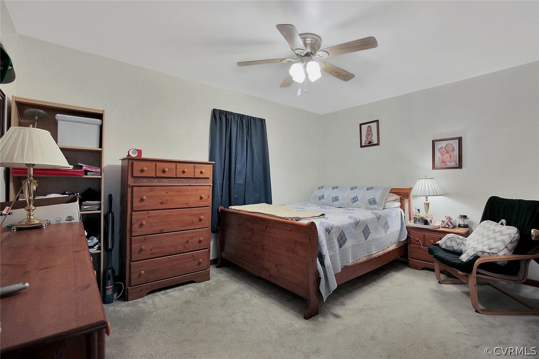11301 Celtic Road Chesterfield, VA 23838 - Photo 19 of 27 a spacious bedroom with a bed and a chandelier