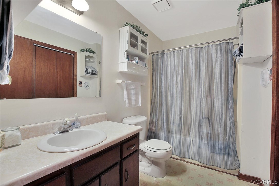 11301 Celtic Road Chesterfield, VA 23838 - Photo 21 of 27 a bathroom with a granite countertop sink toilet a mirror and shower