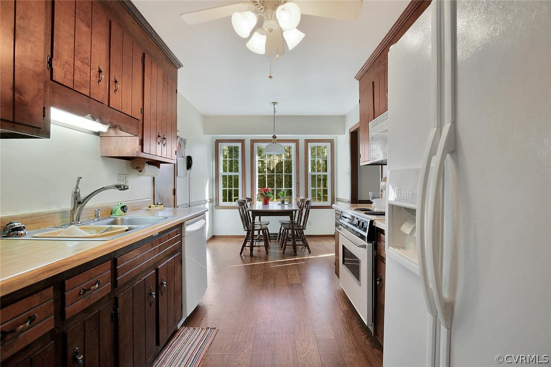 11301 Celtic Road Chesterfield, VA 23838 - Photo 3 of 27 a kitchen with sink a refrigerator and chairs