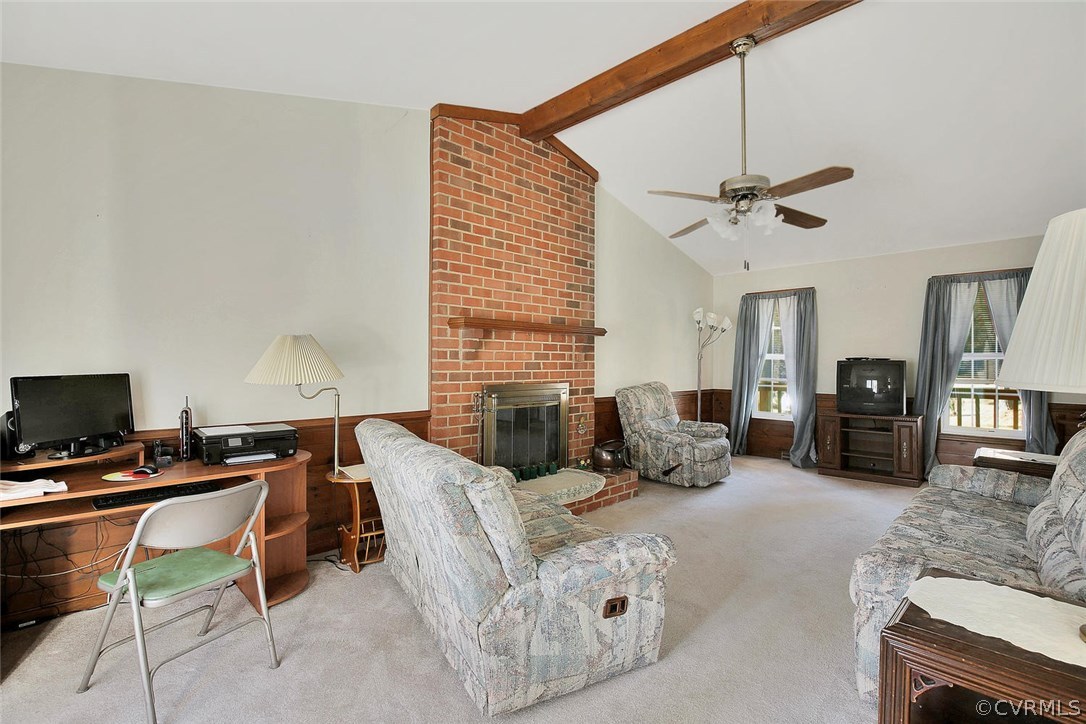 11301 Celtic Road Chesterfield, VA 23838 - Photo 7 of 27 a living room with furniture a fireplace and a flat screen tv