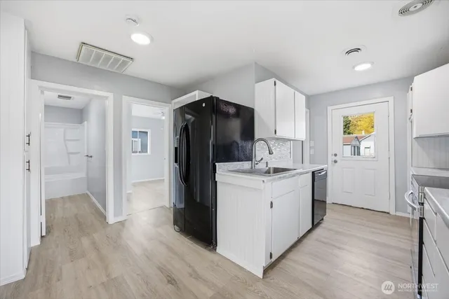 a kitchen with a refrigerator sink and stove