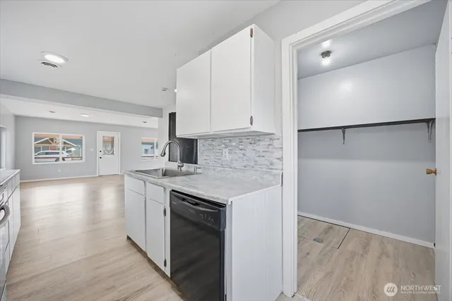 a kitchen with granite countertop a stove and a refrigerator