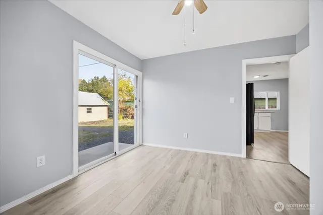 wooden floor in an empty room with a window
