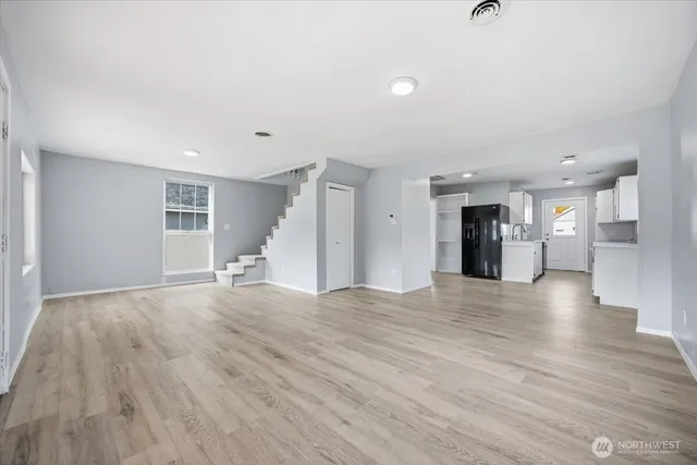 a view of empty room with wooden floor