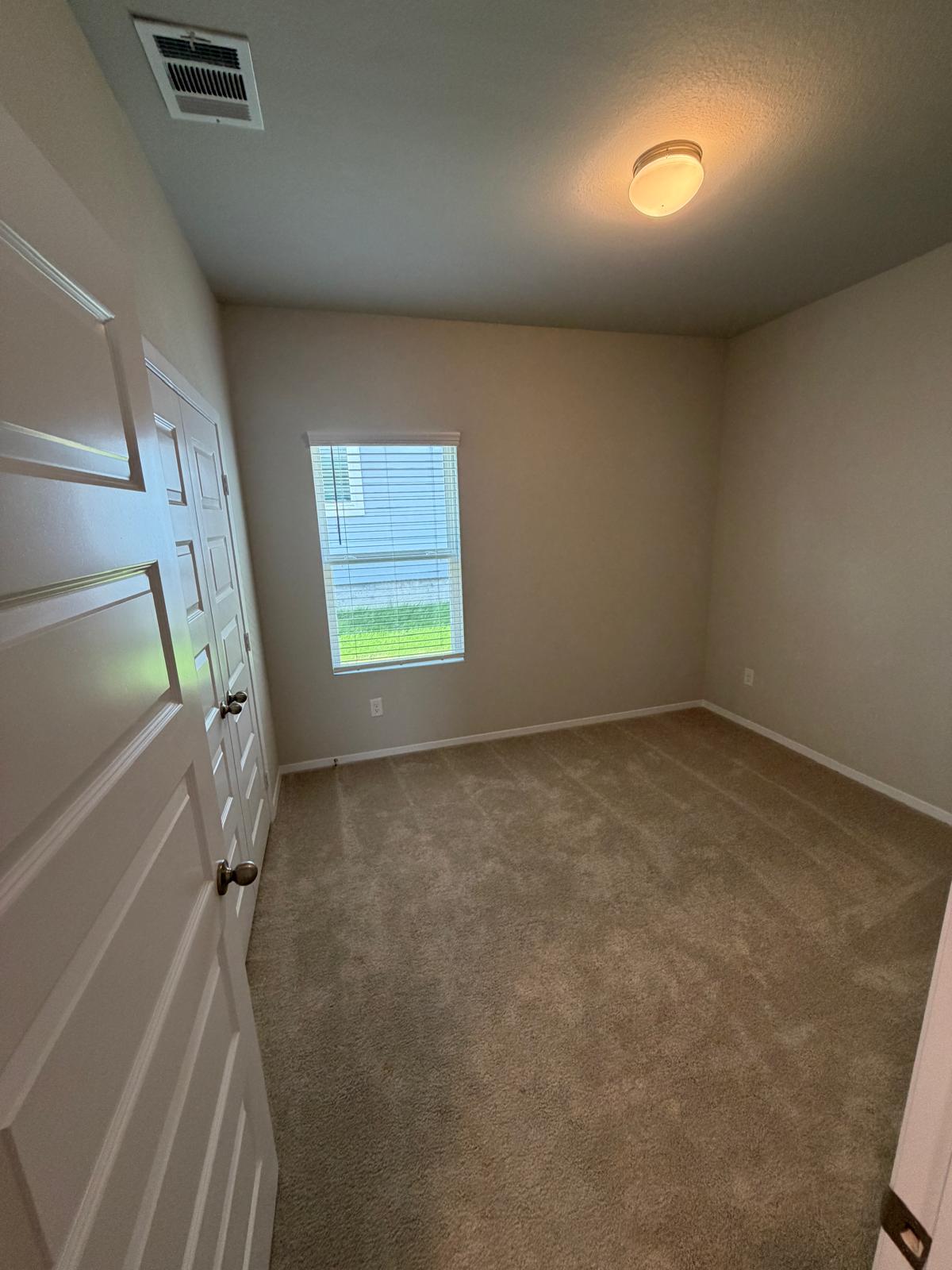 2701 Towy Road Manor, TX 78653 - Photo 16 of 35 A well-lit bedroom features ample floor space and a window with natural light.