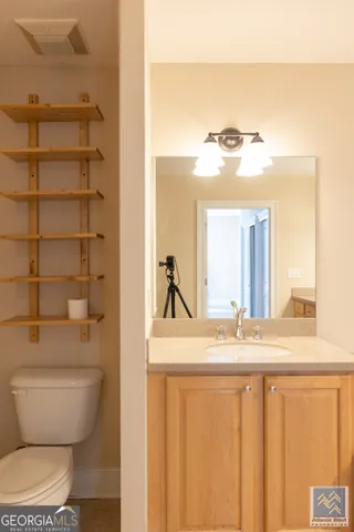 a bathroom with a granite countertop sink and a mirror