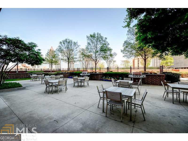 285 Centennial Olympic Park Drive Northwest, Unit 1106 Atlanta, GA 30313 - Photo 30 of 44 a view of a tables and chairs in a patio