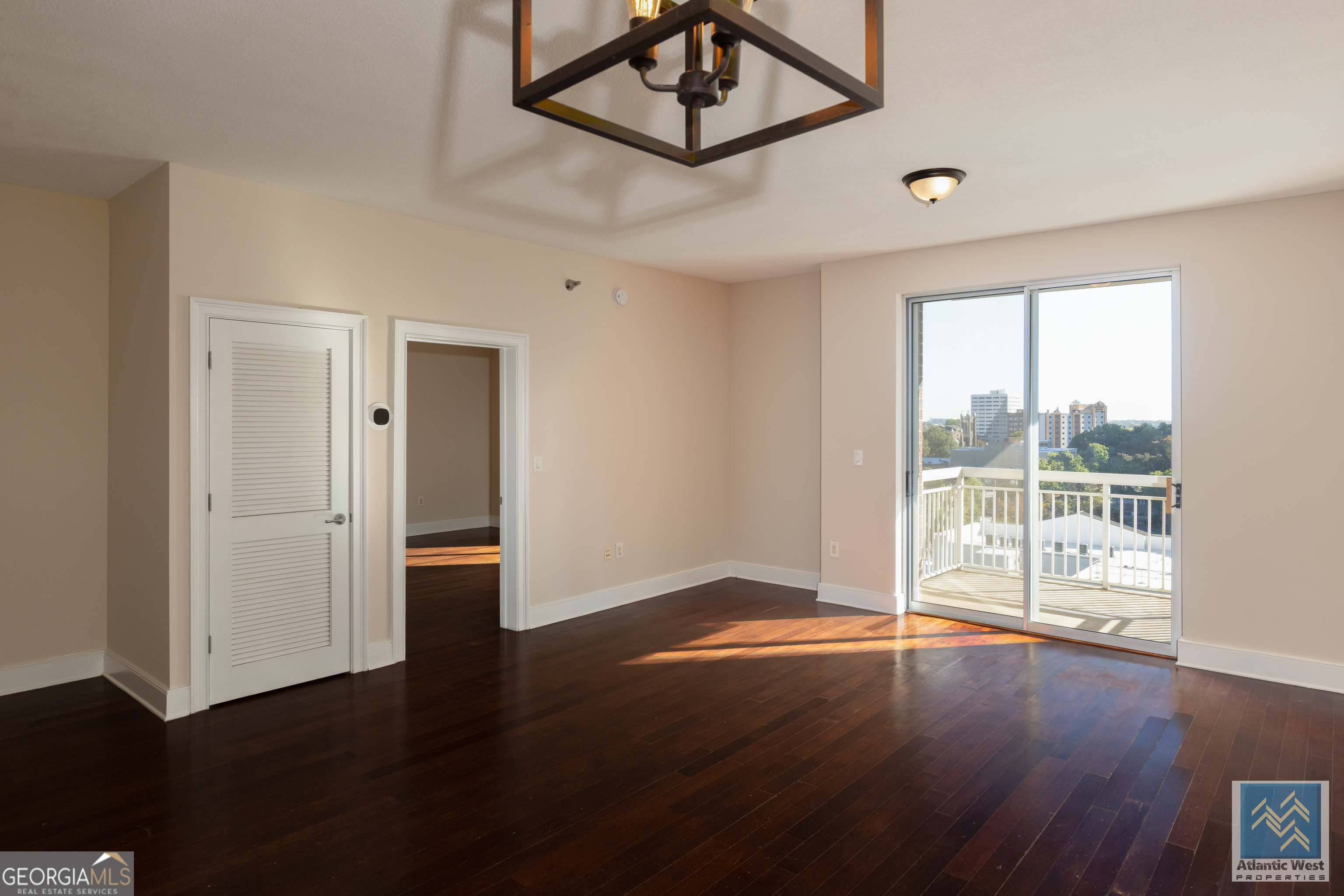 285 Centennial Olympic Park Drive Northwest, Unit 1106 Atlanta, GA 30313 - Photo 3 of 44 a view of an empty room with wooden floor and a window