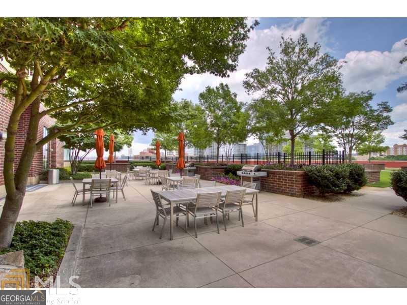 285 Centennial Olympic Park Drive Northwest, Unit 1106 Atlanta, GA 30313 - Photo 32 of 44 a view of a tables and chairs in a patio
