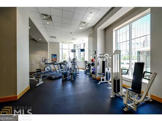 a view of a room with gym equipment and a large window