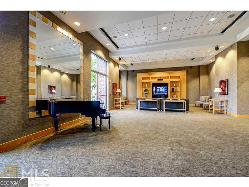 285 Centennial Olympic Park Drive Northwest, Unit 1106 Atlanta, GA 30313 - Photo 35 of 44 a living room with furniture and a large window
