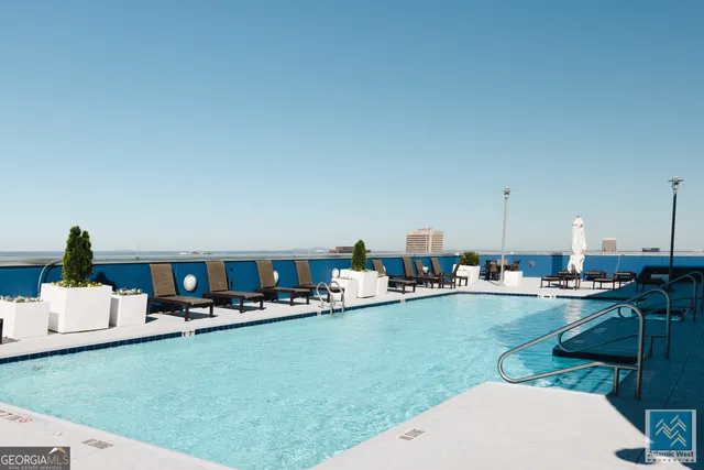 a living room with dining room and kitchen view