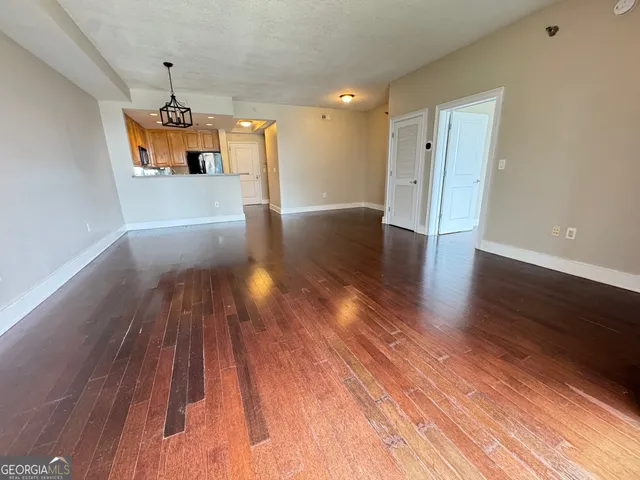 a view of a room with wooden floor and window
