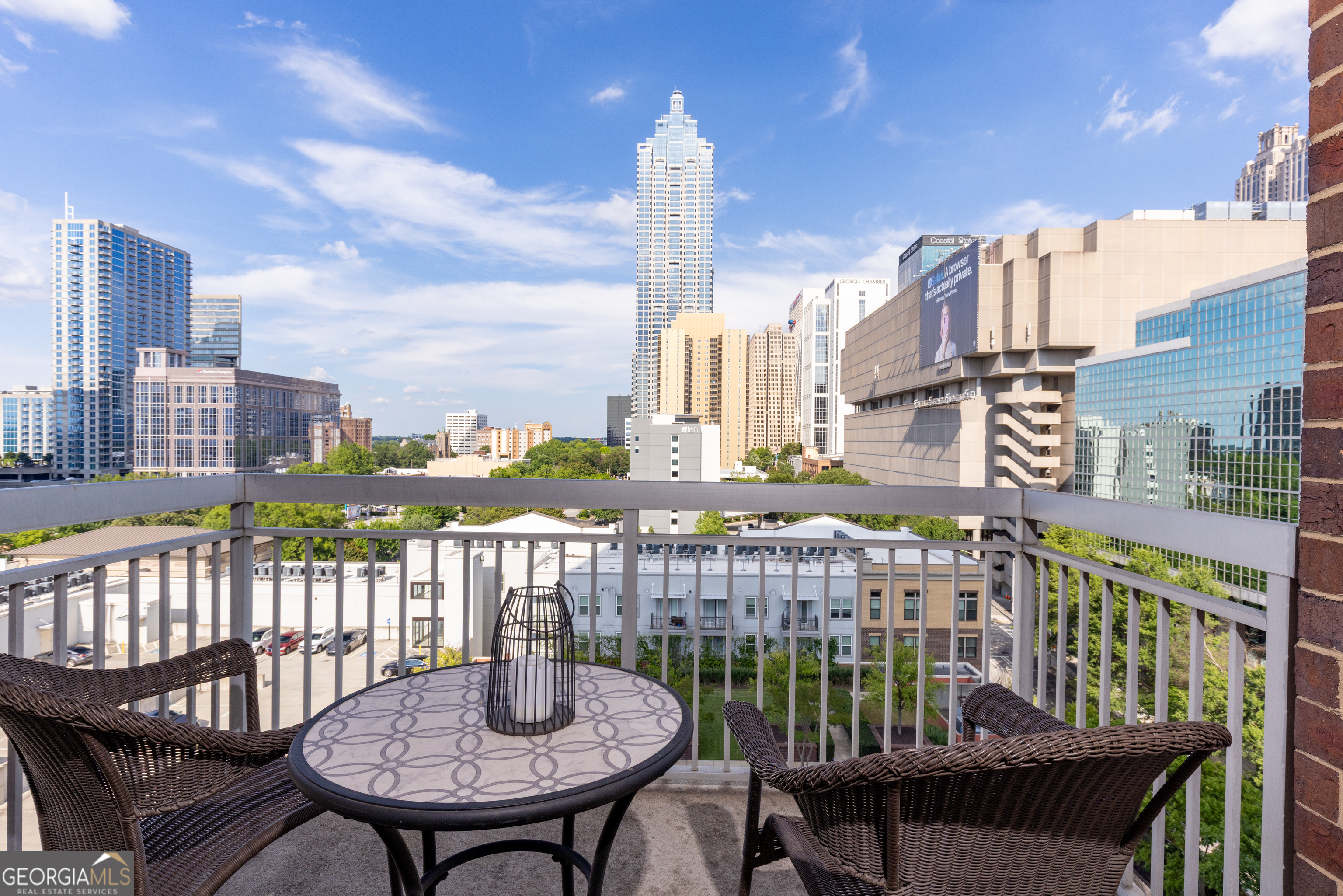 285 Centennial Olympic Park Drive Northwest, Unit 1106 Atlanta, GA 30313 - Photo 10 of 44 a view of a balcony with a table and chairs
