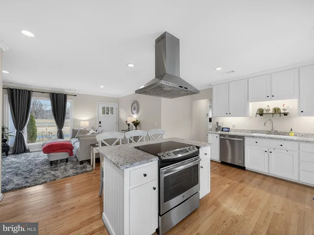 a open kitchen with stainless steel appliances granite countertop a stove and a sink