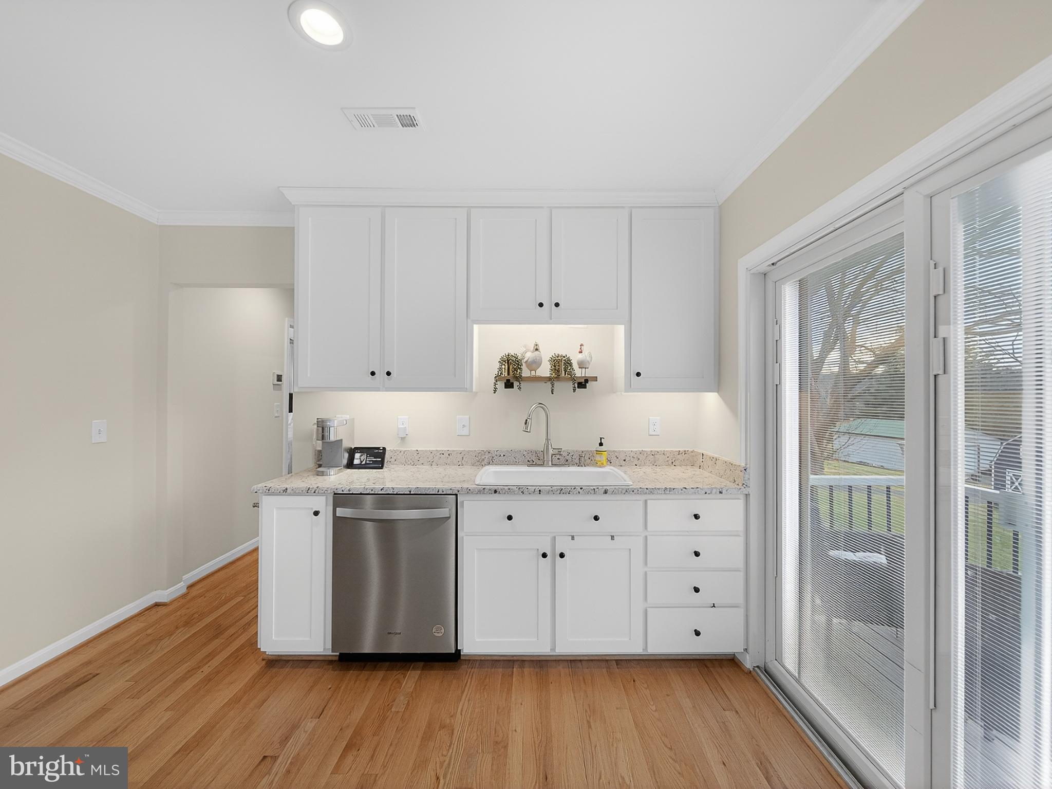 8746 Meetze Road Warrenton, VA 20187 - Photo 14 of 48 a kitchen with a sink cabinets and wooden floor