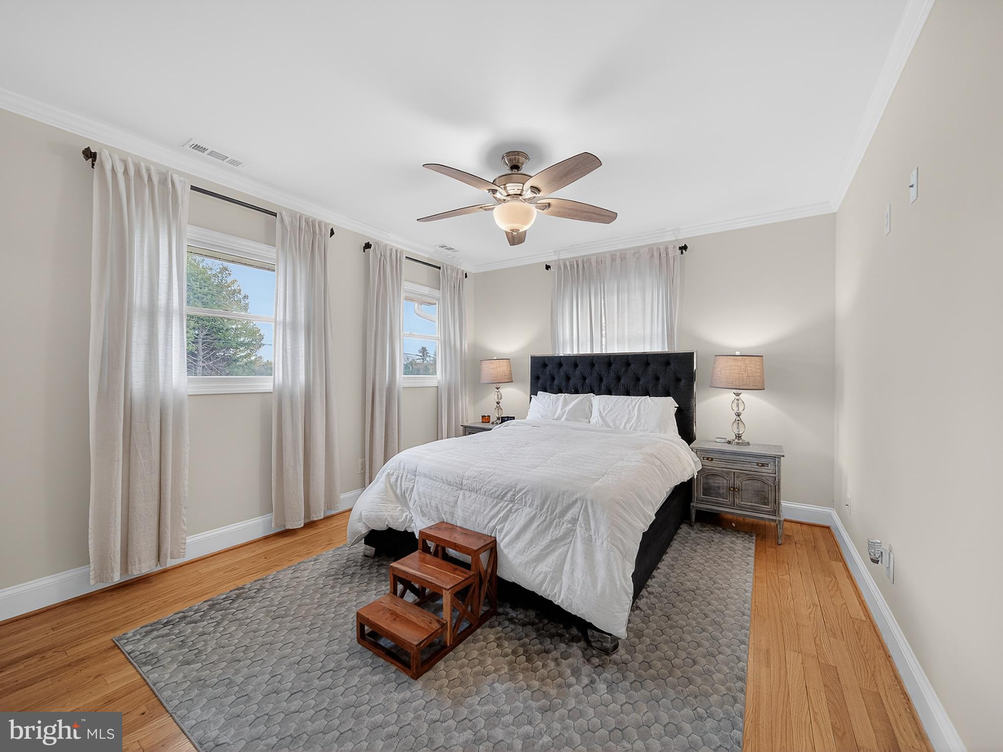 8746 Meetze Road Warrenton, VA 20187 - Photo 17 of 48 a bedroom with a bed and wooden floor