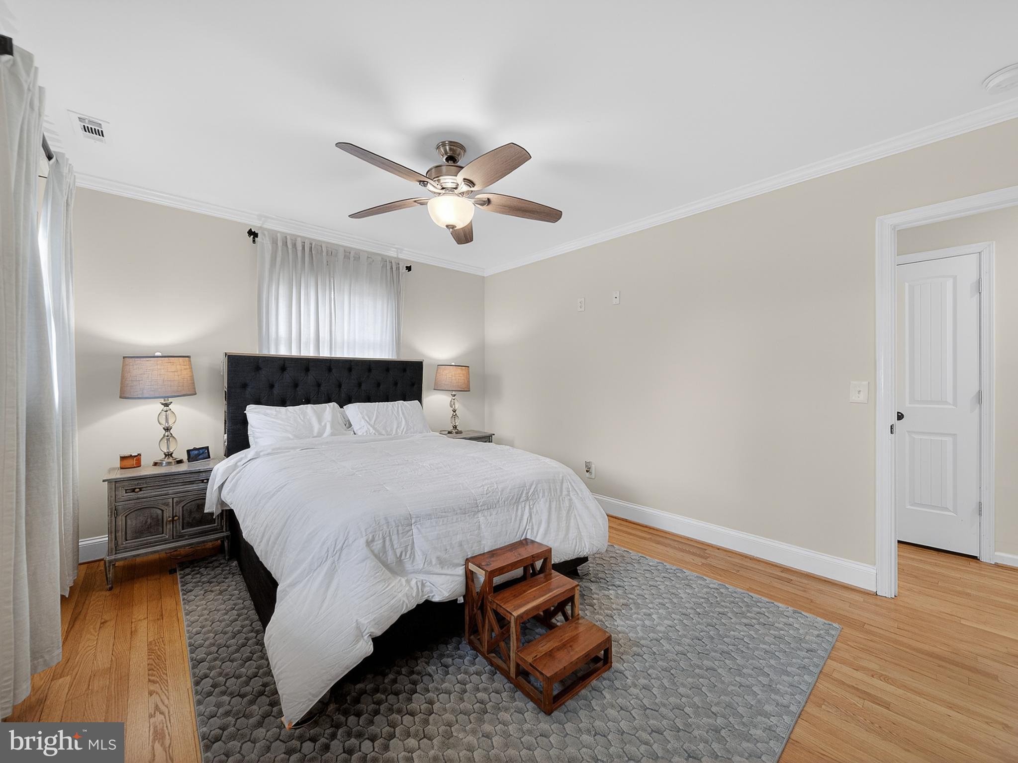 8746 Meetze Road Warrenton, VA 20187 - Photo 18 of 48 a bedroom with a bed and wooden floor