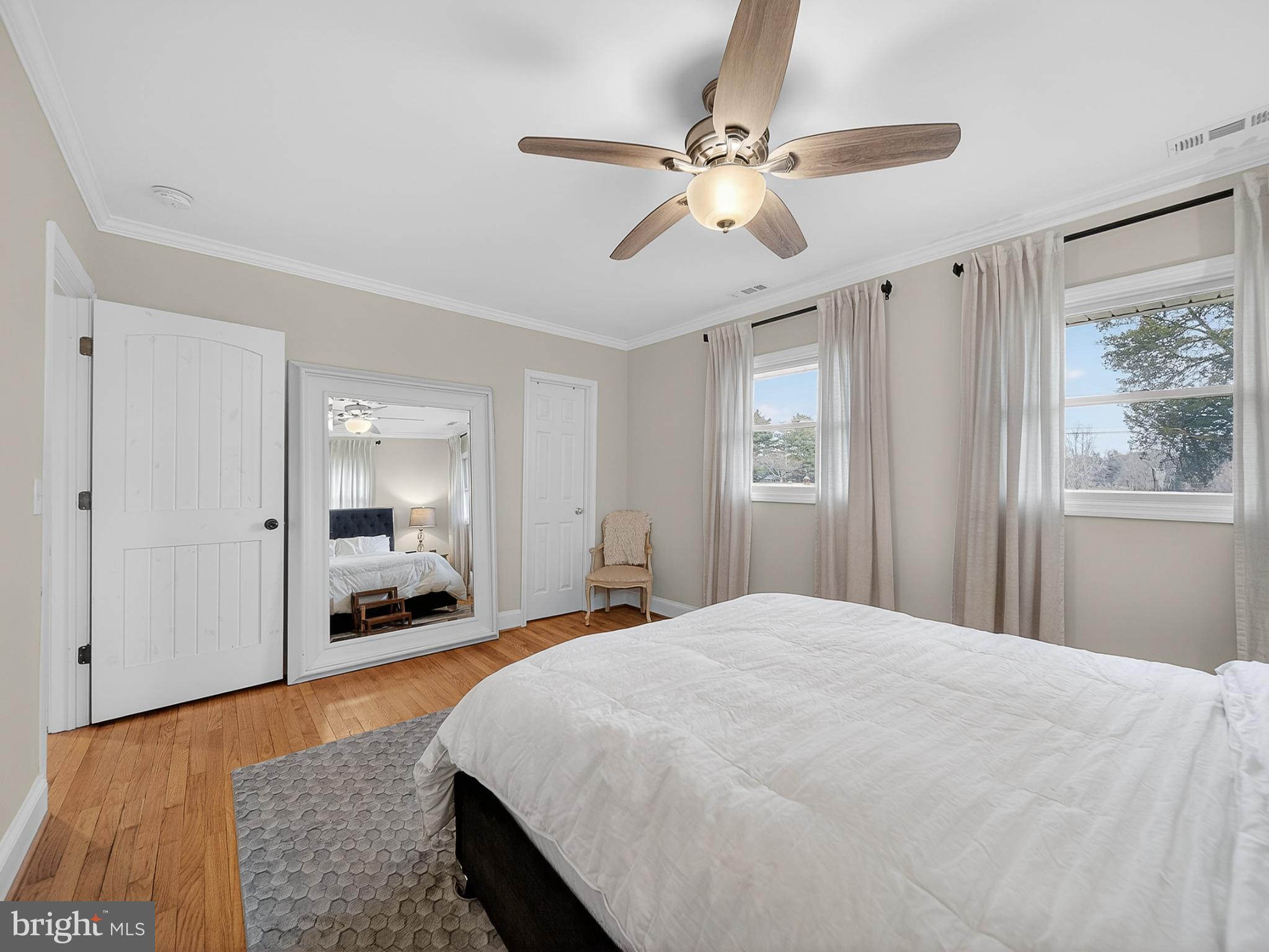 8746 Meetze Road Warrenton, VA 20187 - Photo 19 of 48 a bedroom with a large bed and a chandelier