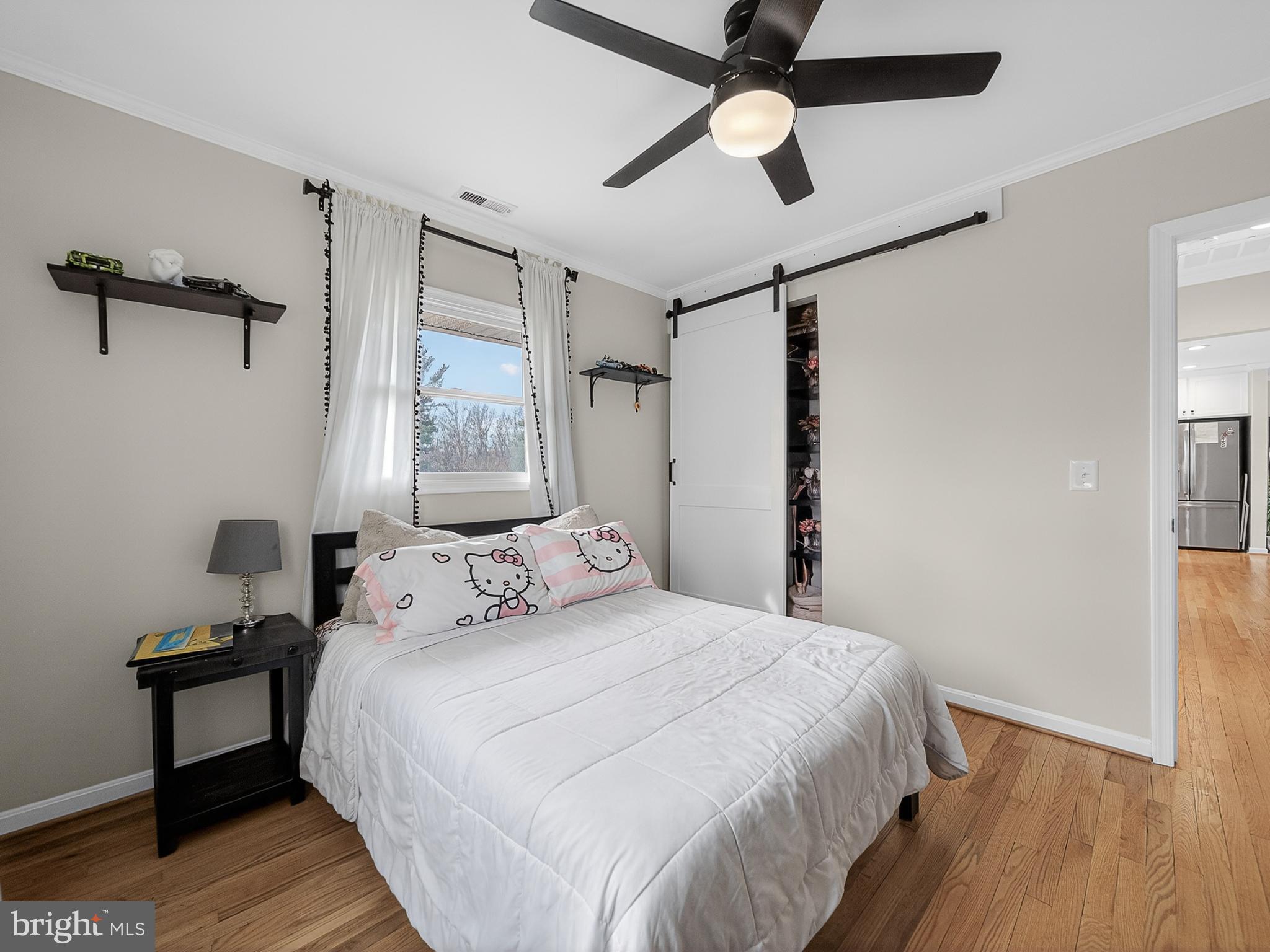 8746 Meetze Road Warrenton, VA 20187 - Photo 21 of 48 a bedroom with a bed and a chandelier