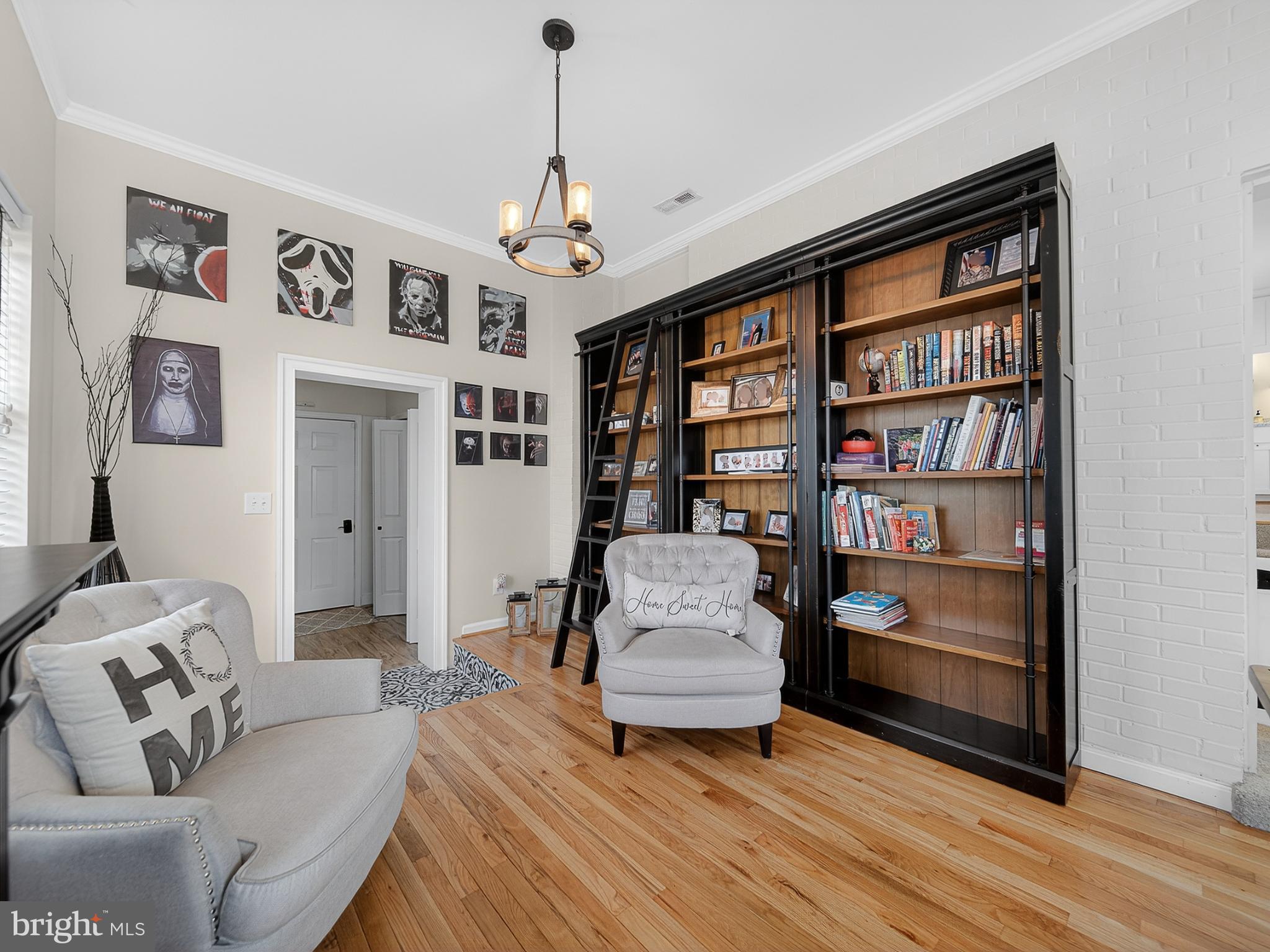8746 Meetze Road Warrenton, VA 20187 - Photo 28 of 48 a living room with furniture and a book shelf