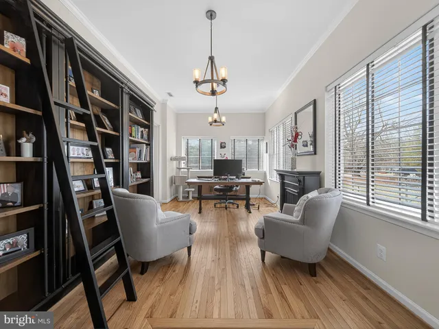 a living room with fireplace furniture and a book shelf