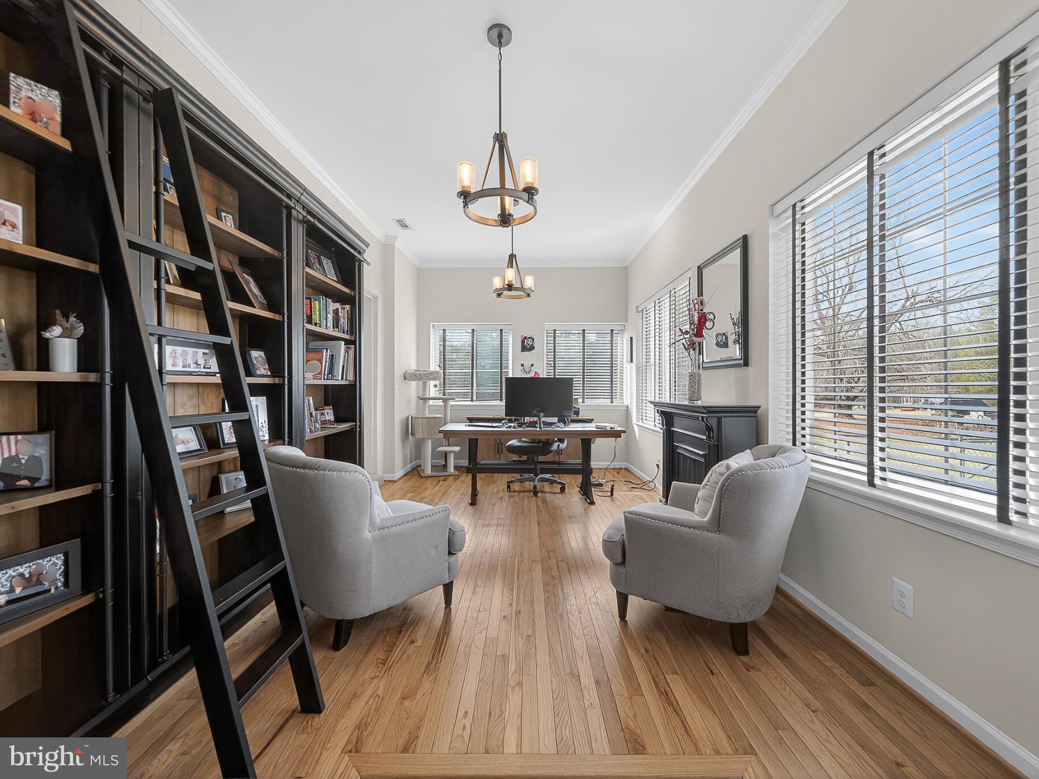 8746 Meetze Road Warrenton, VA 20187 - Photo 29 of 48 a living room with fireplace furniture and a book shelf